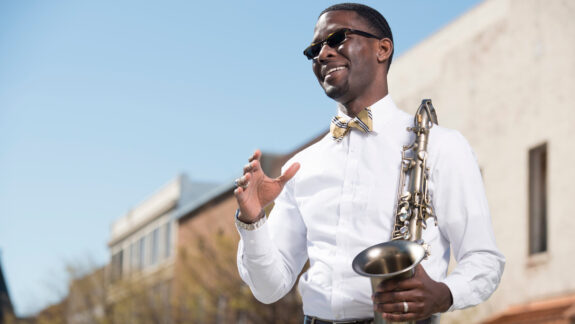 Man Smiling with Saxophone